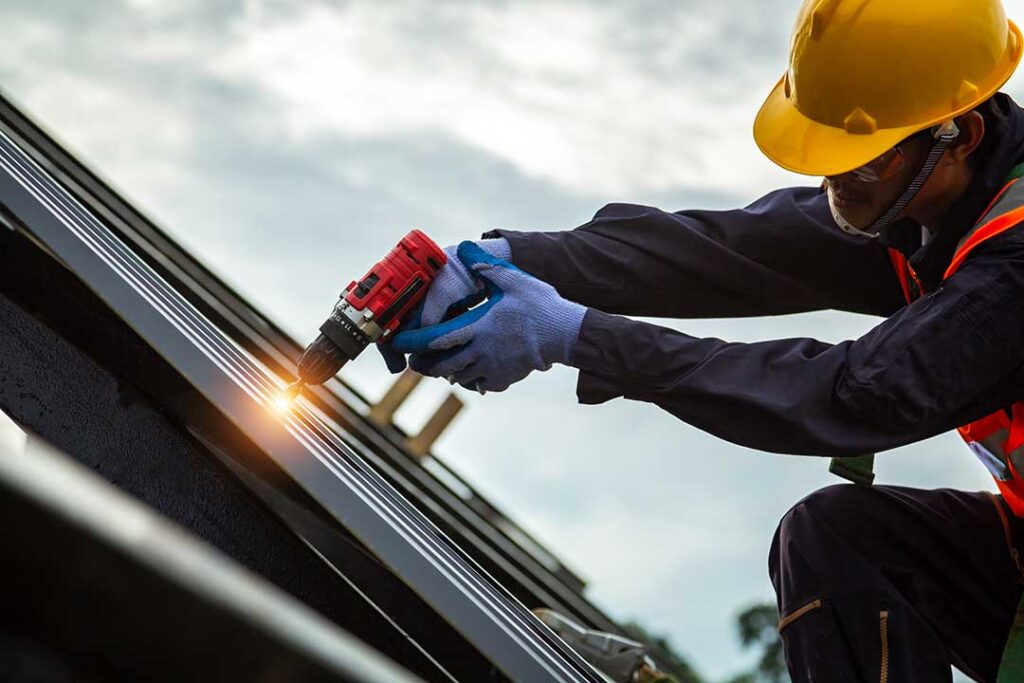 Residents sort shingles, metal flashing, and roofing debris into separate covered containers.