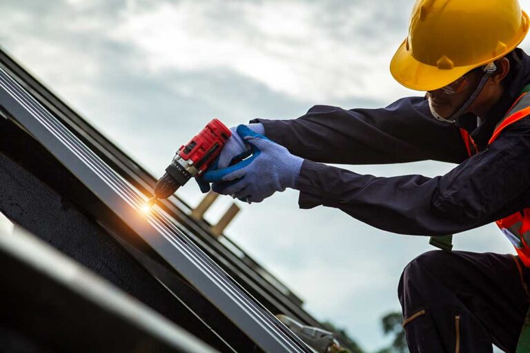Residents sort shingles, metal flashing, and roofing debris into separate covered containers.